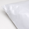 Close-up detailfoto van een witte LDPE verzendzak met glanzende afwerking, waarbij de linkerachterhoek en de textuur van het stevige kunststofmateriaal zichtbaar zijn.